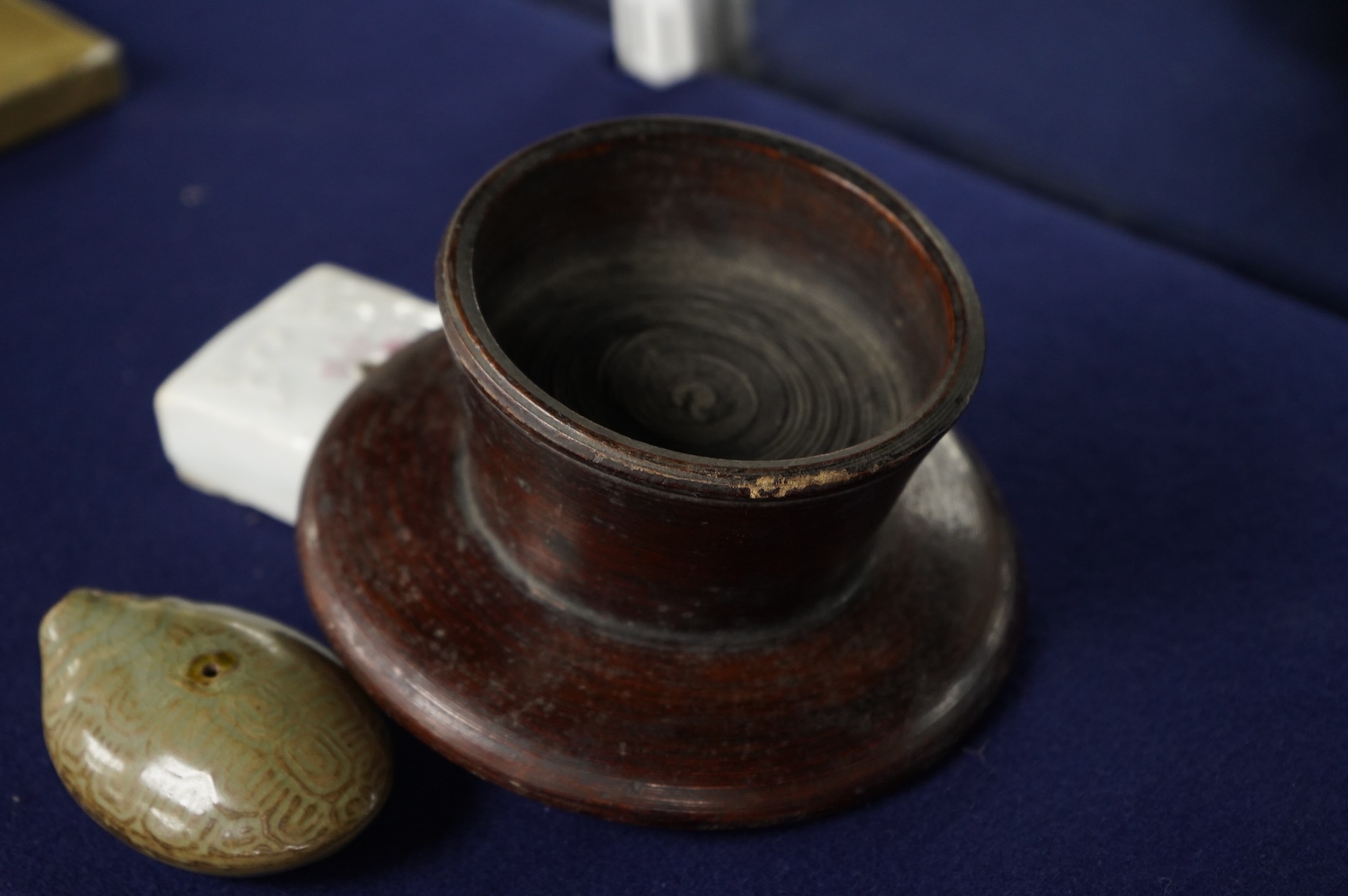 Two 19th century Korean ceramic water droppers and a Korean turned wood cup stand, oval water dropper 8cm long